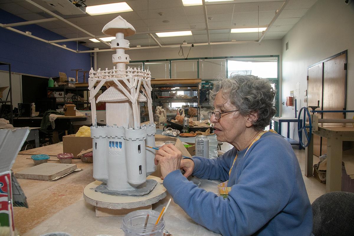 Lady painting an art project.