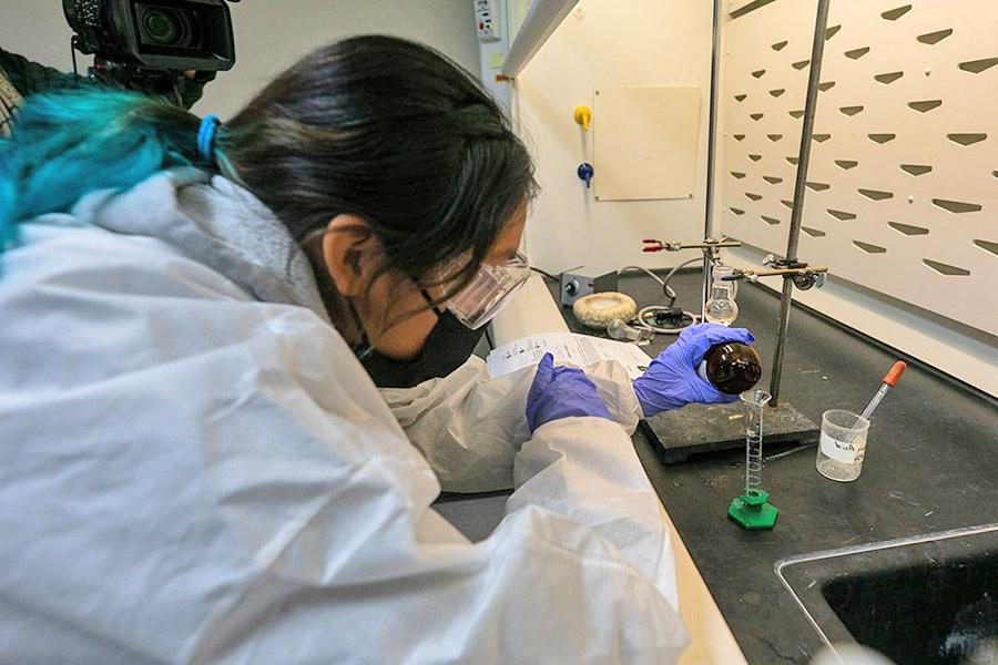 Student works with fluids and test tubes in chemistry class