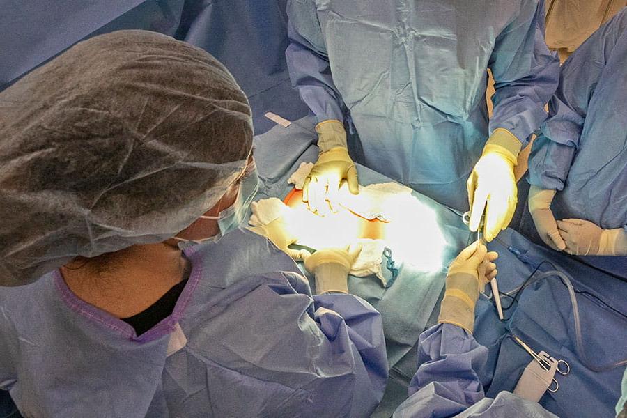 An overhead view of surgeons working on a patient